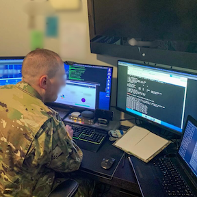 Soldier using multiple screens to track training.